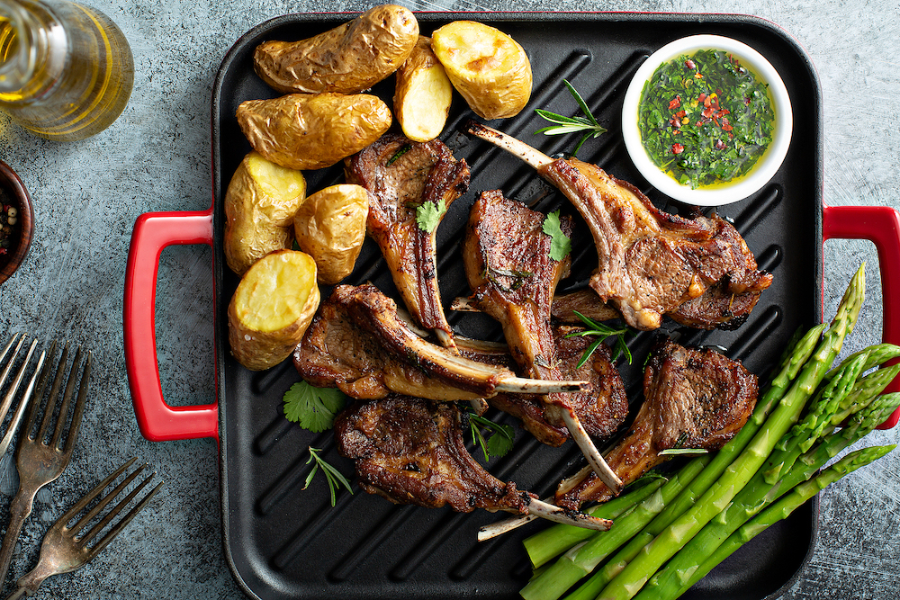 Grilled lamb chops with green herb sauce, asparagus and potatoes