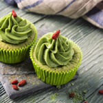 Matcha cup cakes on a wooden background