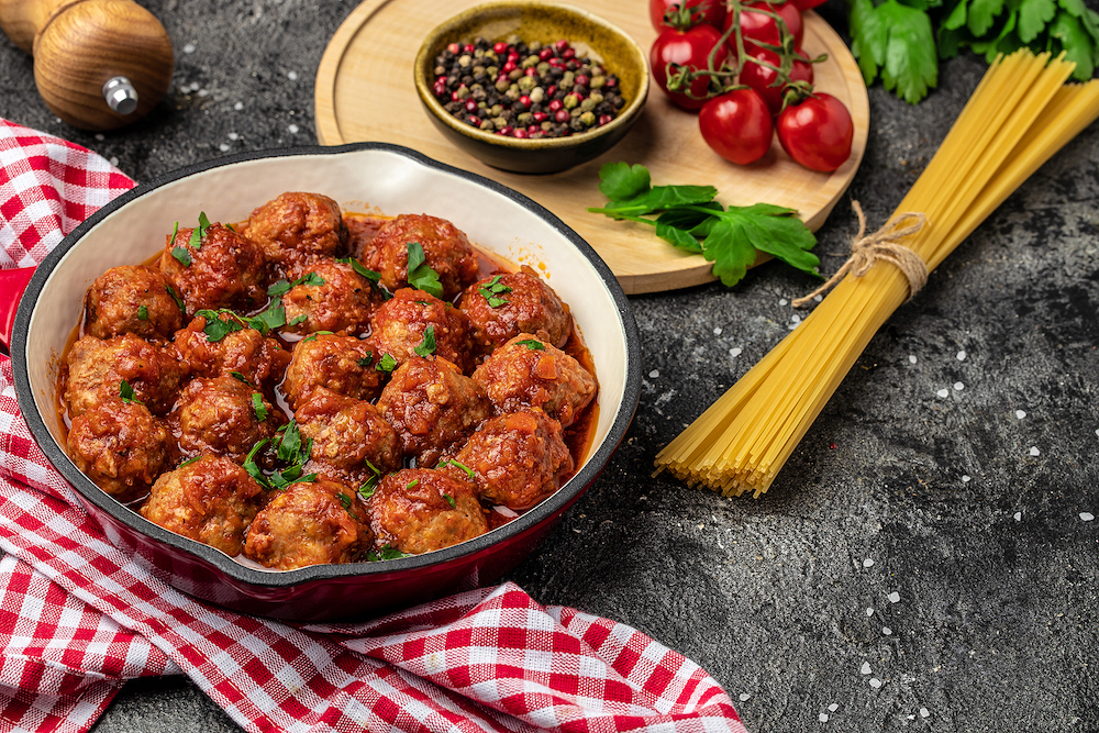 Traditional spicy meatballs in sweet and sour tomato sauce. Restaurant menu, dieting, cookbook recipe top view.