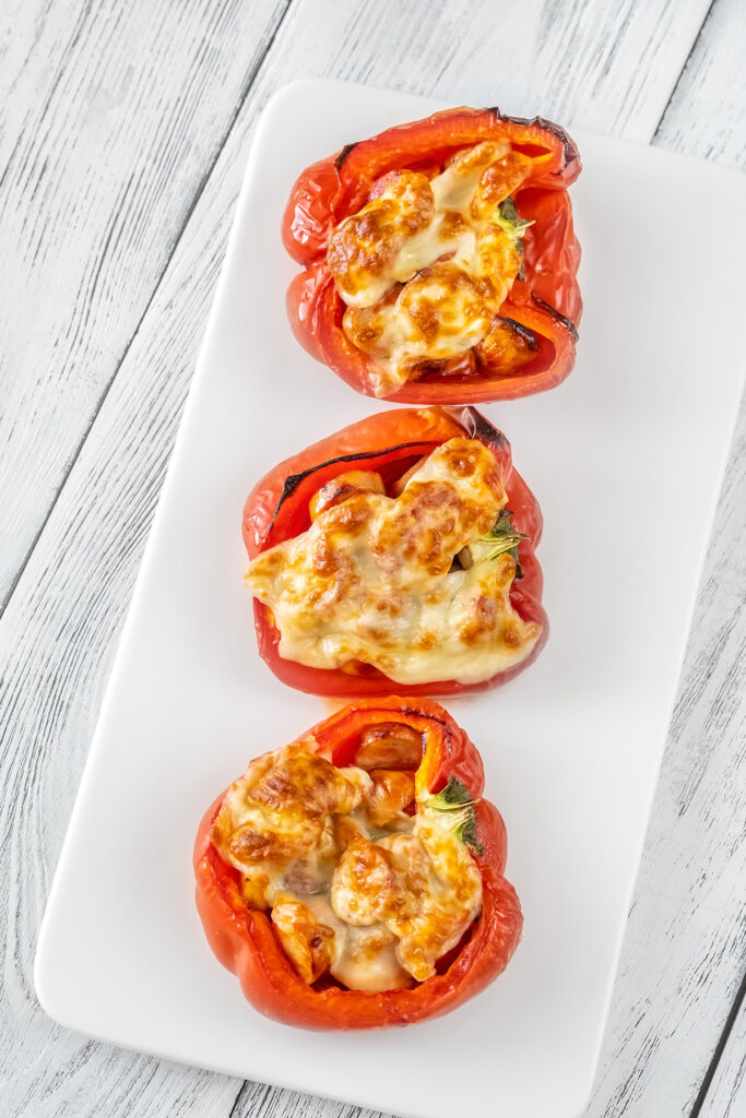Baked bell peppers stuffed with sausage and topped with mozzarella