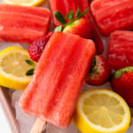 Strawberry Lemon Popsicles with slices of lemon and strawberries on ice