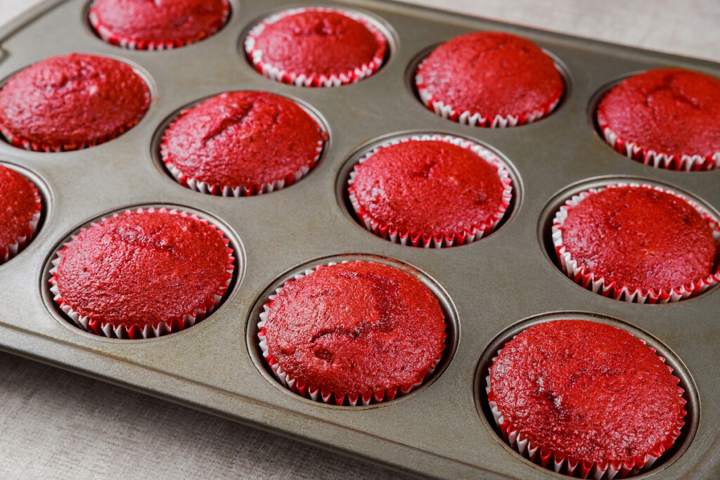Delicious red velvet cupcakes in oven pen. Close up.